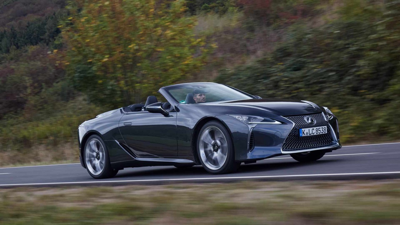 Seitenansicht des neuen Lexus LC500 auf einer Fahrt auf einer Autobahn in einer grünen Umwelt.
