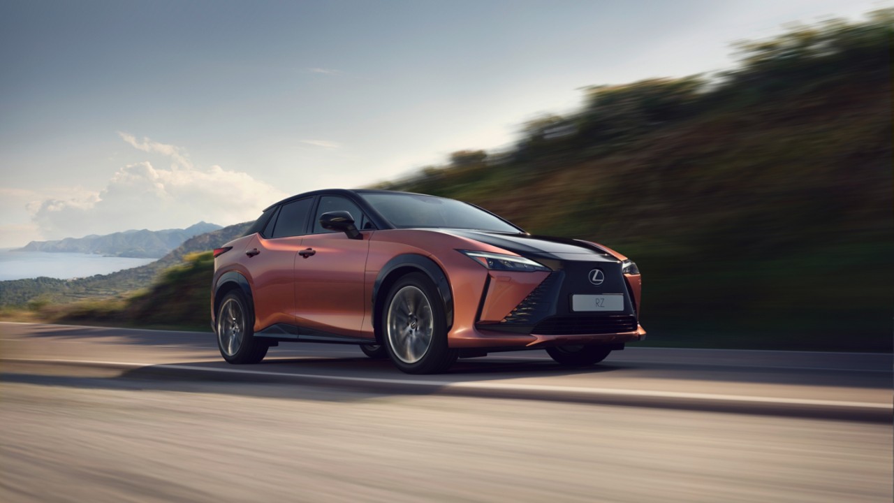 A Lexus RZ 450e plugged into a charging tower