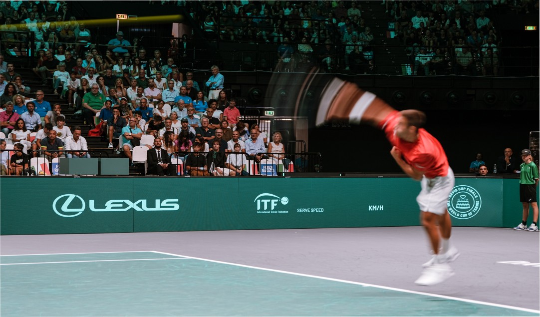 A tennis player serving on court